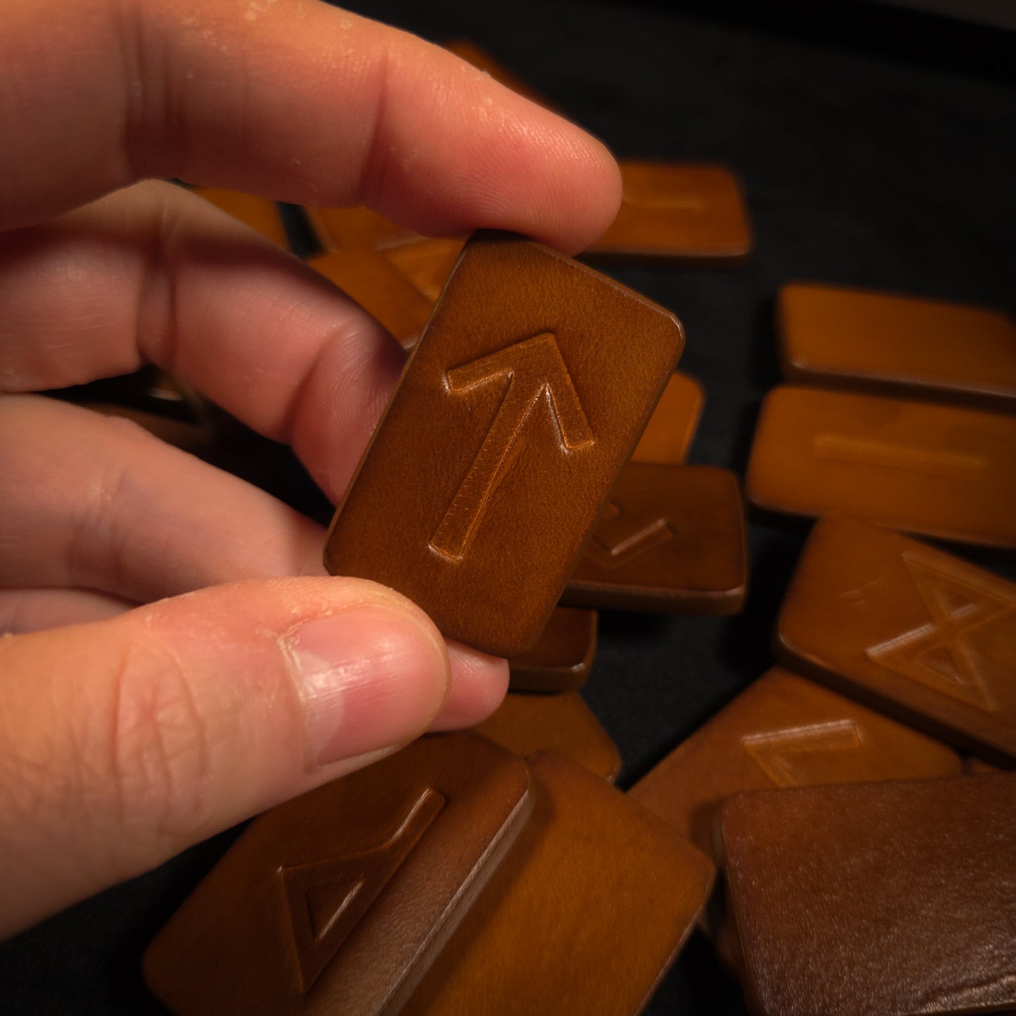 Holding a single Leather Elder Futhark Rune